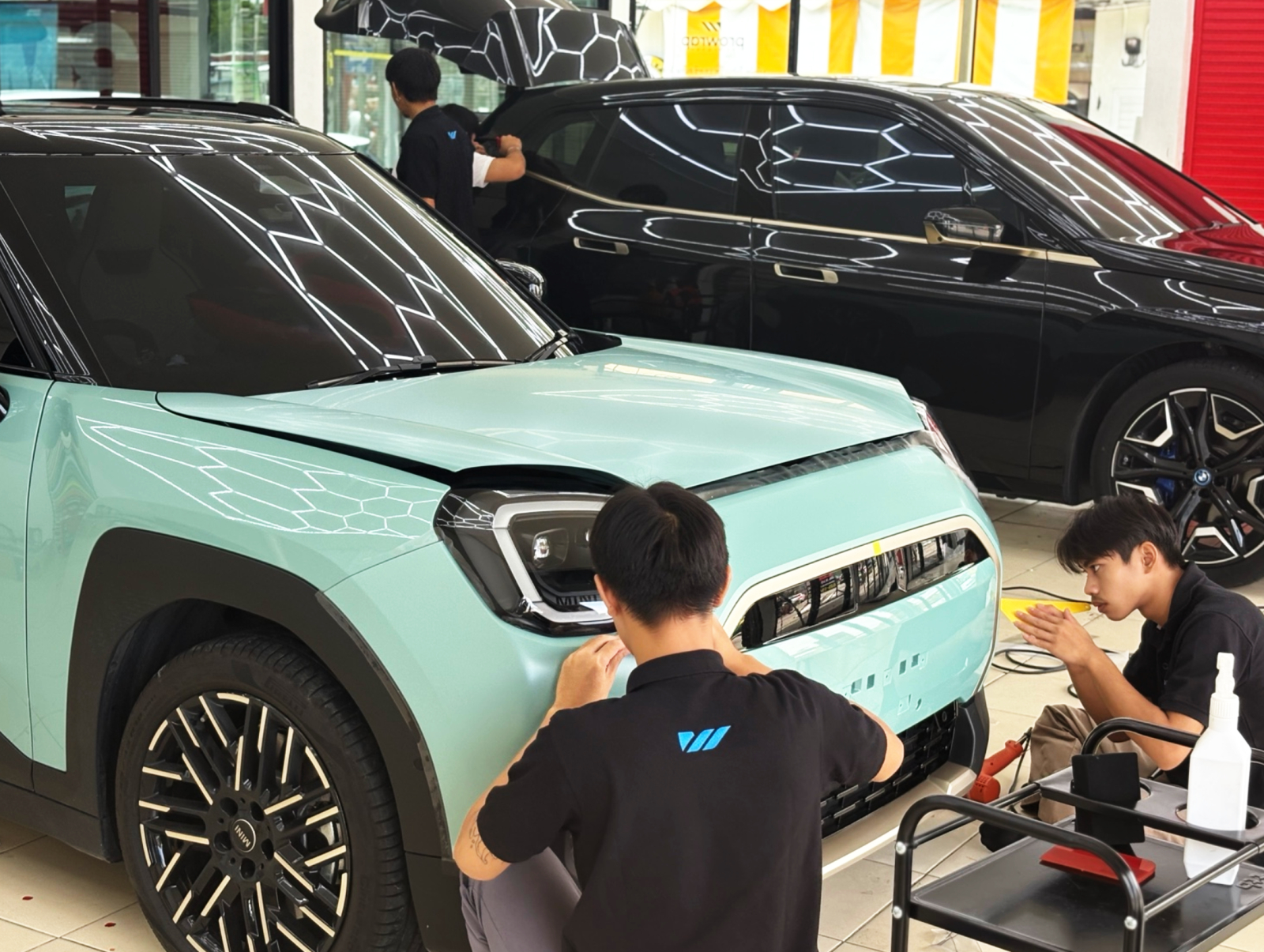 PROWRAP installation team working on a car